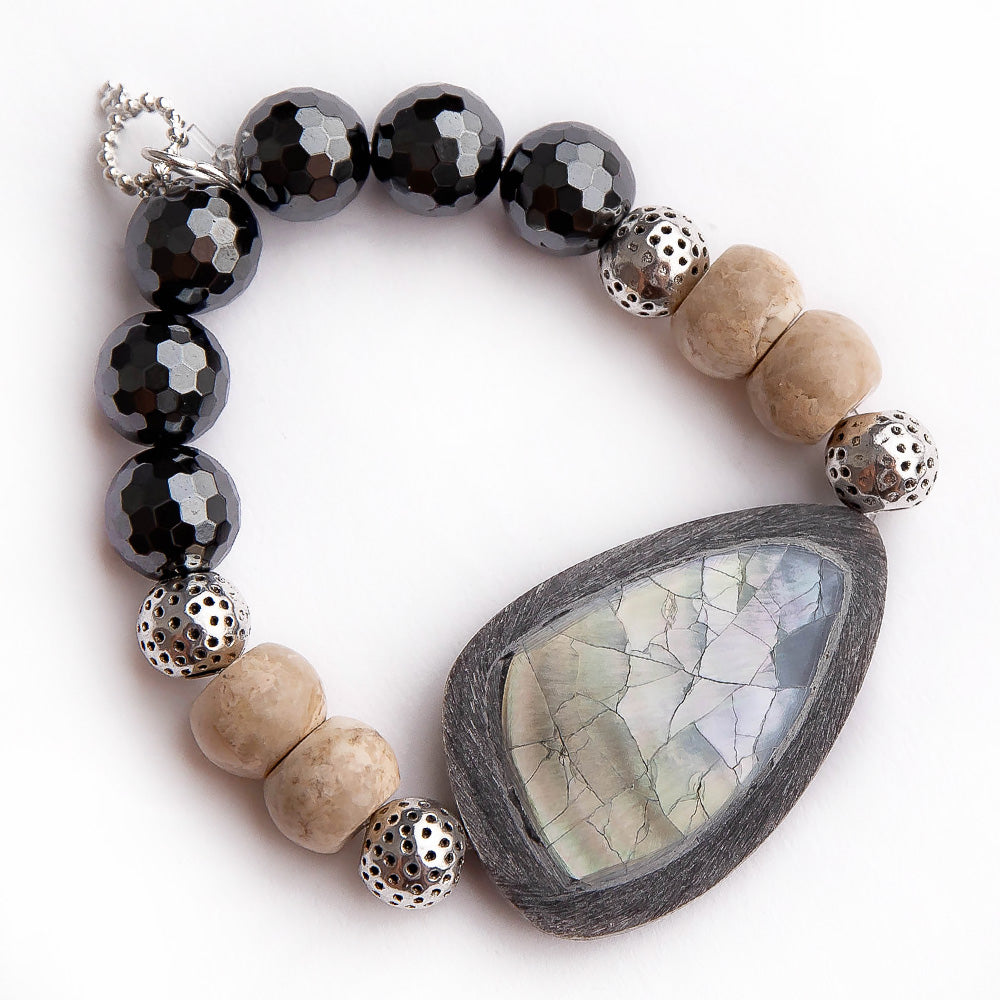Faceted gunmetal hematite paired with Abalone and driftwood statement slice