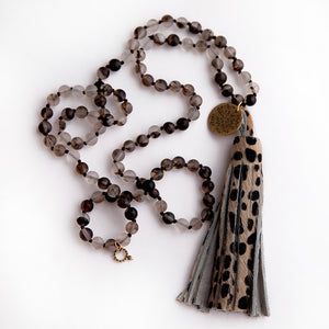 Matte grey owl hand tied quarz paired with a cheetah leather tassel featuring a brass spirit medal