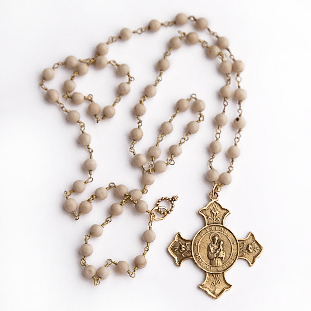 Cream coral rosary chain gemstone necklace paired with a brushed bronze Saint Anthony cross