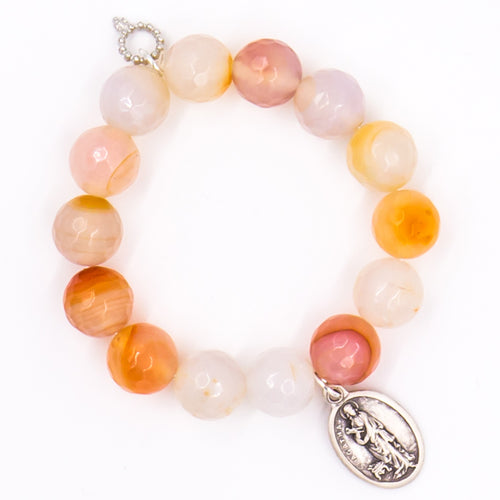 Faceted Bermuda agate with silver Saint Agatha medal
