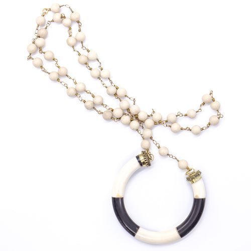 Cream coral with lucky horseshoe bone pendant