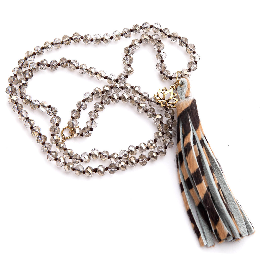 Faceted Light Grey Quartz hand tied gemstone necklace paired with a tiger print leather tassel featuring small brass lotus