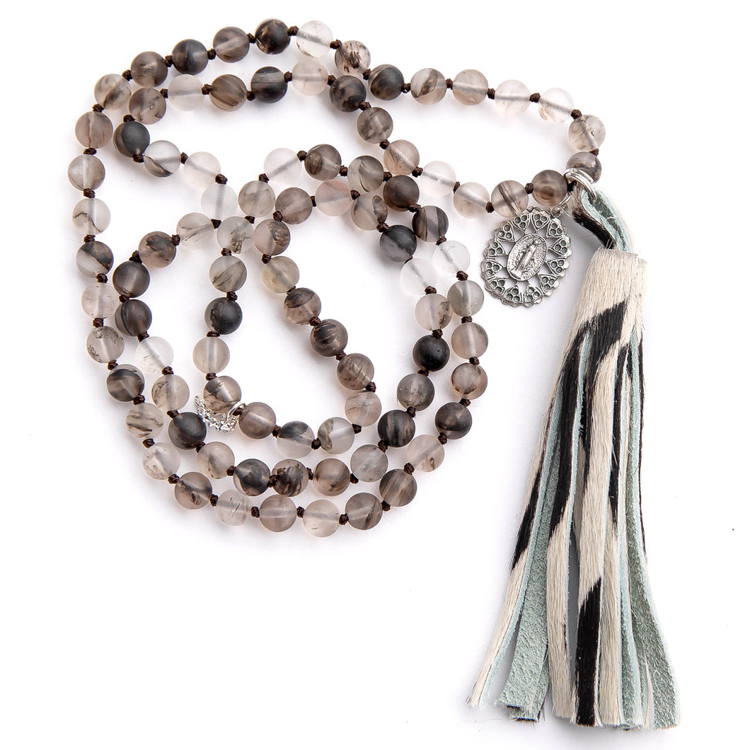 Hand tied matte grey owl quartz gemstone necklace hand tied paired with a zebra print leather tassel featuring ornate blessed mother