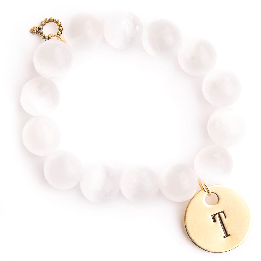 White calcite paired with a brass hand stamped initial medal