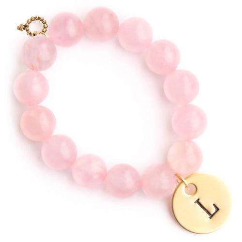 Rose quartz paired with a brass hand stamped initial medal