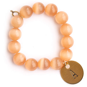 Cashmere calcite paired with a brass hand stamped initial disc