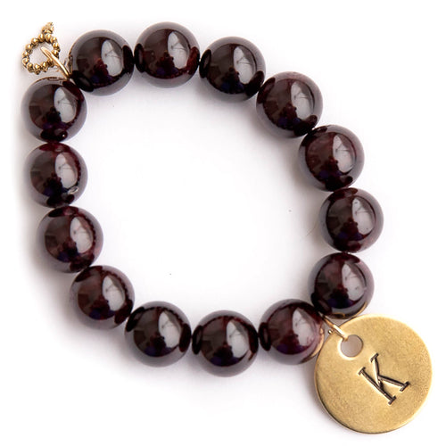 Garnet paired with a brass hand stamped initial medal