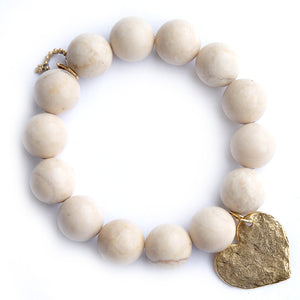 Cream coral paired with a brass hammered heart