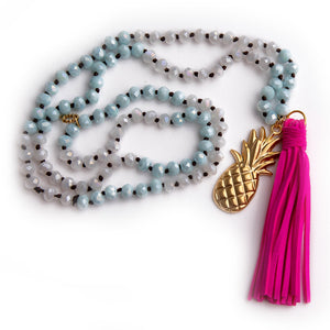 Hand tied faceted two tone aqua and white quartz gemstone necklace paired with a hot pink leather tassel featured with a brass pineapple