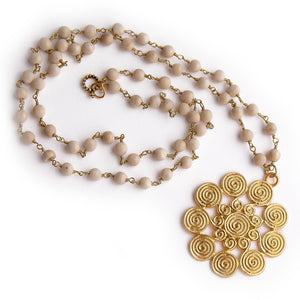 Cream coral rosary chain paired with a gold spiral pendant