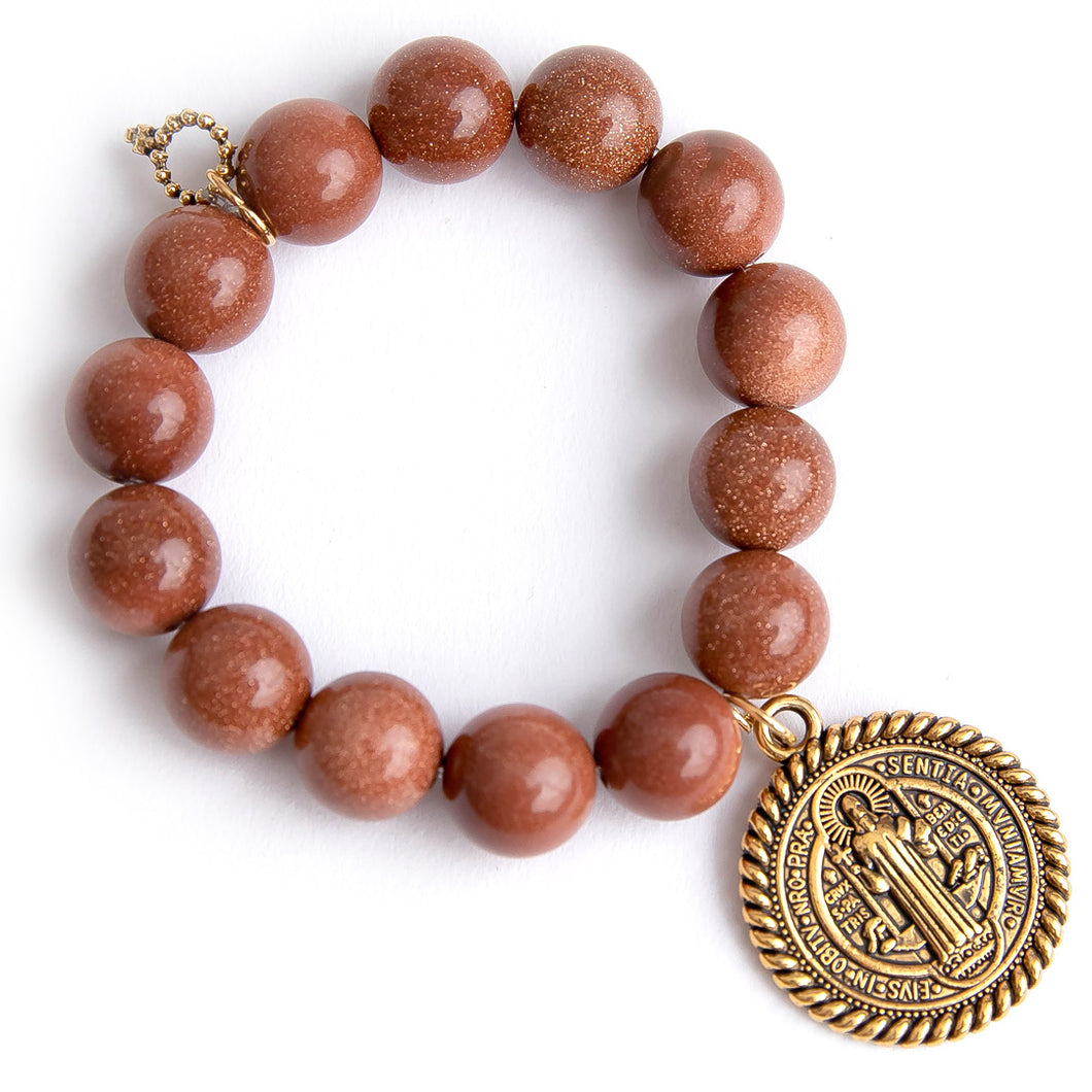 Amber goldstone paired with a large brass Saint Benedict