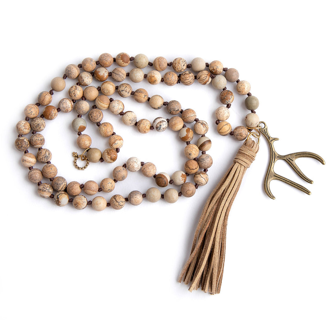 Hand tied matte picture jasper paired with a suede tassel and bronze antler medal