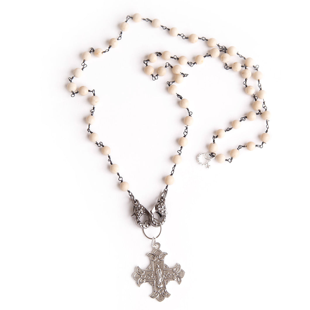 Cream coral face mask necklace featuring an exclusively casted silver Sacred Heart cross pendant