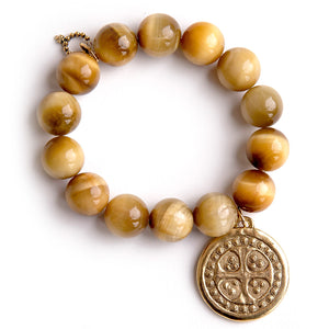 Sunkissed tiger eye paired with a brushed gold dotted cross disc