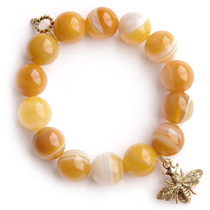Butterscotch agate paired with a brass queen bee