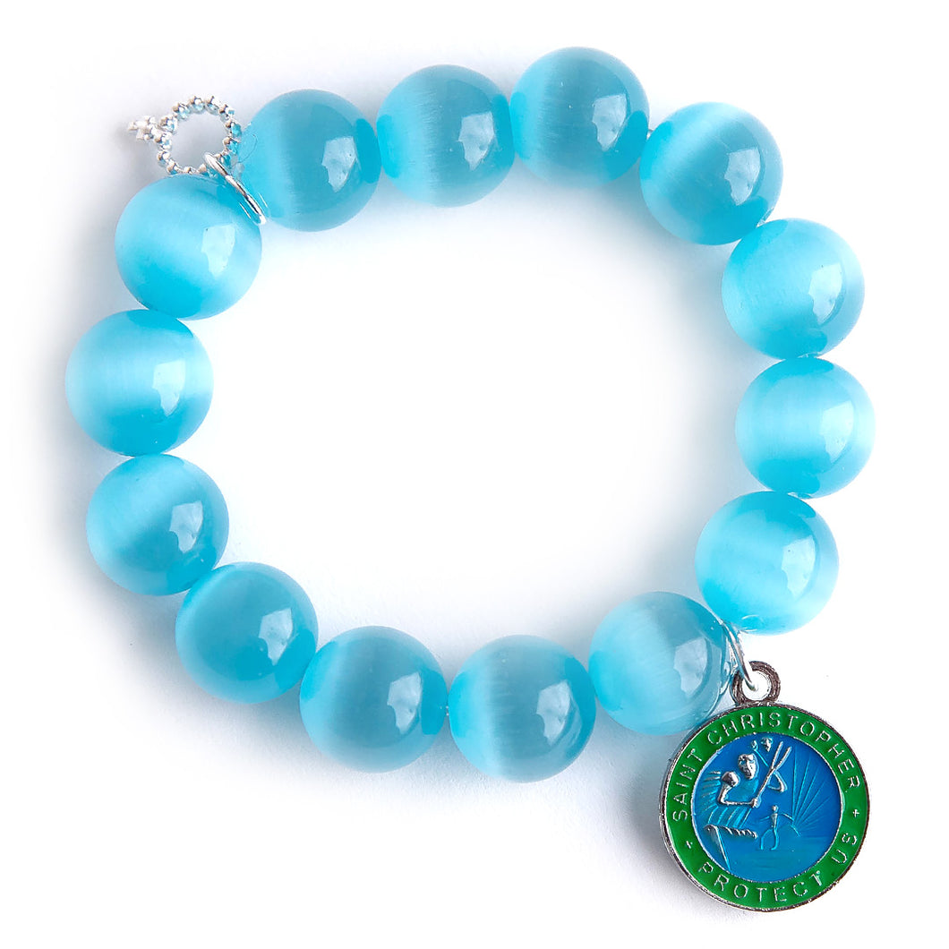 Tidal Pool Calcite paired with a blue & green enameled Saint Christopher