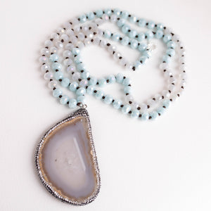 Hand tied faceted two tone aqua and white quartz necklace paired with a pave surround agate slice