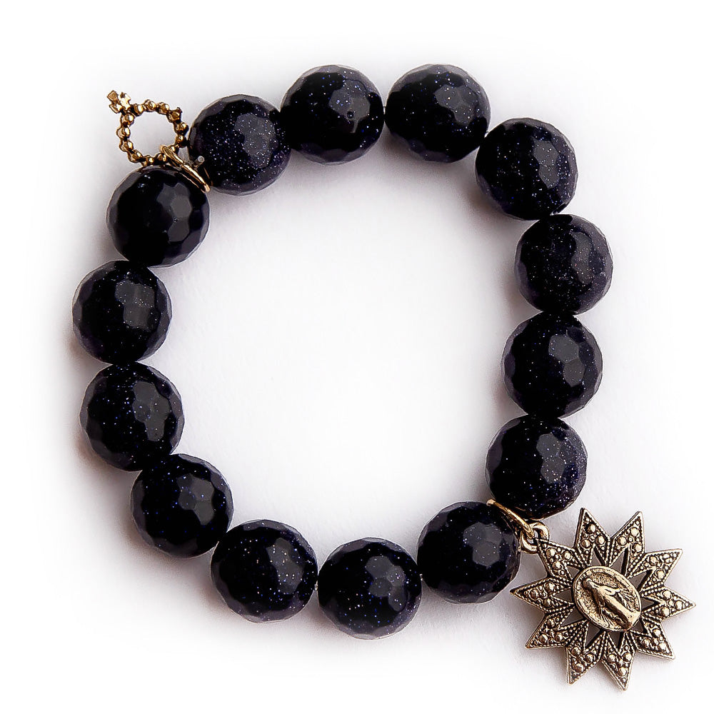Faceted navy goldstone with gold starburst miraculous medal
