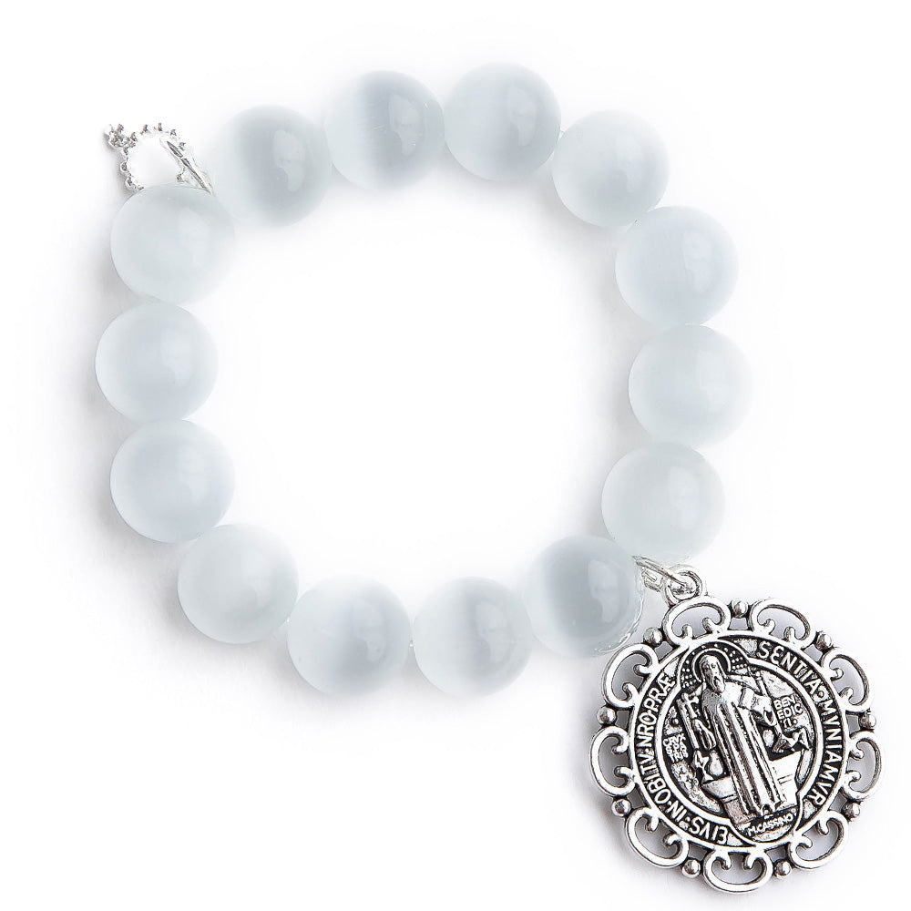 White calcite paired with an ornate Saint Benedict medal